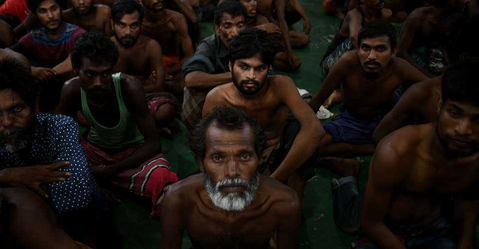 Illegal Bangladeshi migrants wait at the police headquarters in Langkawi on May 11, 2015, after arriving on Malaysian shores earlier in the day.