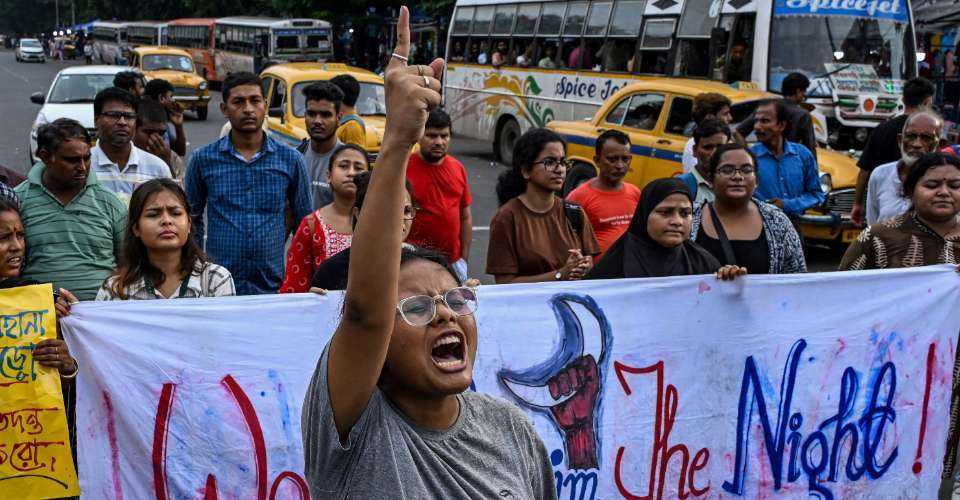 Activists shout slogans and display banners during a protest rally to condemn the rape and murder of a doctor in India's West Bengal state, in Kolkata on Aug. 25.