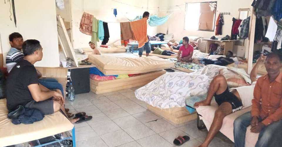 Bangladeshi nationals rest at a shelter camp in northern Saida.