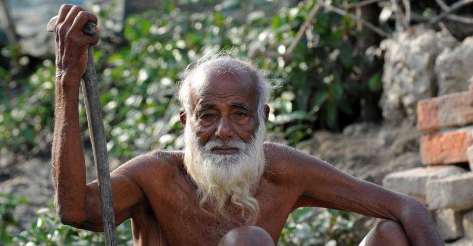 An elderly Bangladeshi man looks on at a village near the Sunderbans in Khulna, some 350 km southwest of Dhaka, on March 31, 2009. The Sundarbans, meaning 'beautiful jungle' in Bengali, is the world's largest mangrove forest covering over 10,000 square kilometers. Six thousand square kilometres of the forest are in Bangladeshi territory while the remainder is spread across India's West Bengal state.