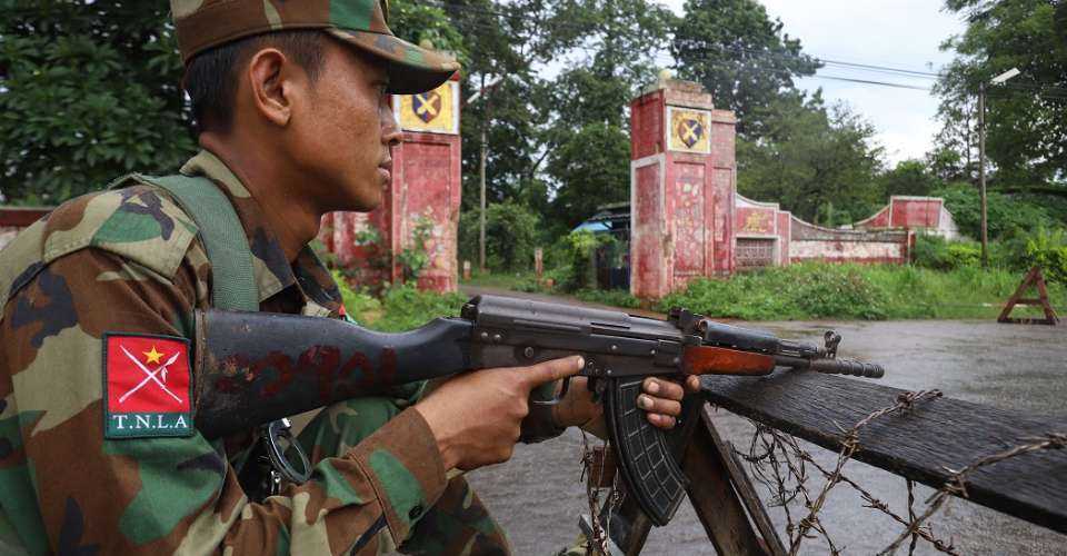 This July 3, 2024 photo shows a member of the ethnic armed group Ta'ang National Liberation Army (TNLA) keeping watch at a checkpoint in the town of Kyaukme in Myanmar's northern Shan State. Residents of Kyaukme in northern Myanmar were left counting their dead and picking through rubble following fresh fighting that shredded a Beijing-brokered ceasefire between the junta and an alliance of armed ethnic groups.