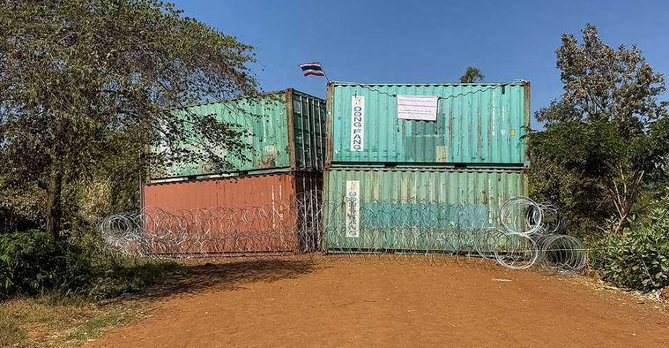This handout photograph taken and released by Agence Kampuchea Press (AKP) on Jan 2 shows Thailand's national flag on containers and barbed wire blocking a street following clashes between Cambodian and Thai soldiers, in Chouk Chey village in Banteay Meanchey province. Cambodia said on Jan 2 that Thai forces had taken control of a disputed border village, accusing Thailand of 'annexing' the area after a truce halted deadly fighting along their contested frontier a week ago